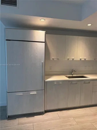 a view of a kitchen with a refrigerator a sink and a refrigerator