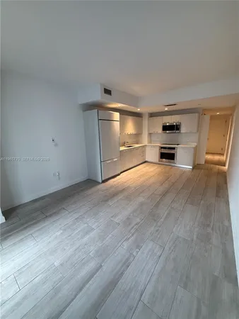 a view of a kitchen with a sink and dishwasher cabinets with wooden floor