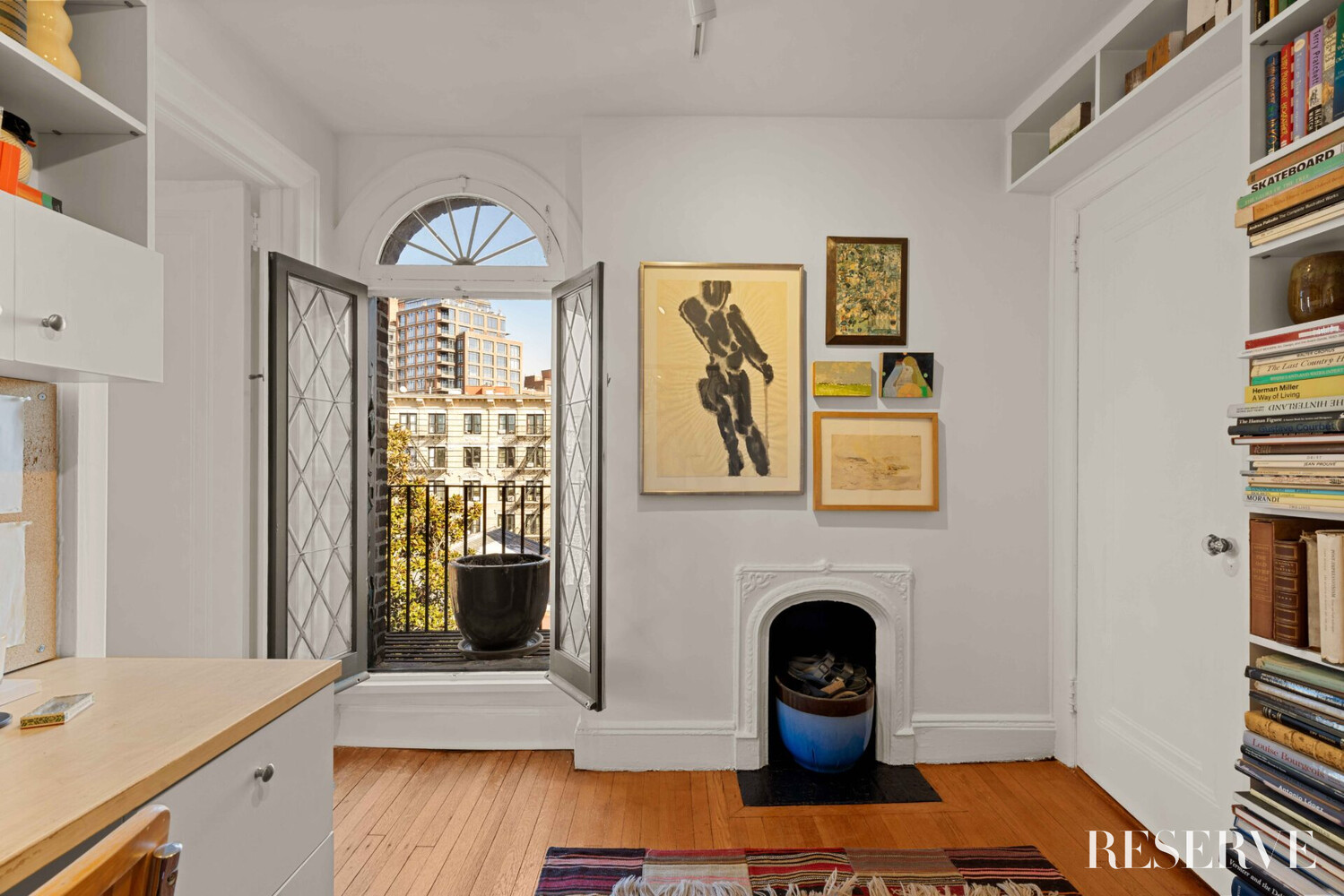 29 Perry Street, Unit 5R Manhattan, NY 10014 - Photo 10 of 14 a living room with furniture and a fireplace