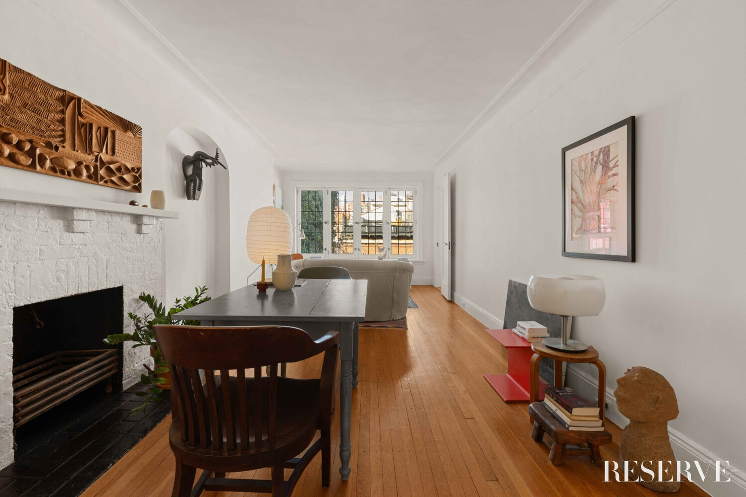 29 Perry Street, Unit 5R Manhattan, NY 10014 - Photo 4 of 14 a view of a dining room with furniture a fireplace and wooden floor