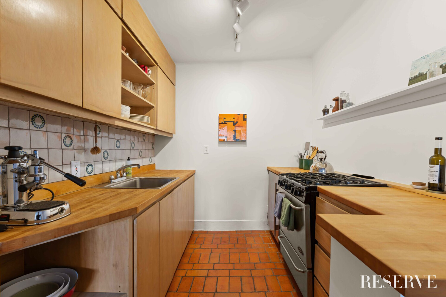 29 Perry Street, Unit 5R Manhattan, NY 10014 - Photo 6 of 14 a kitchen that has a sink and a stove