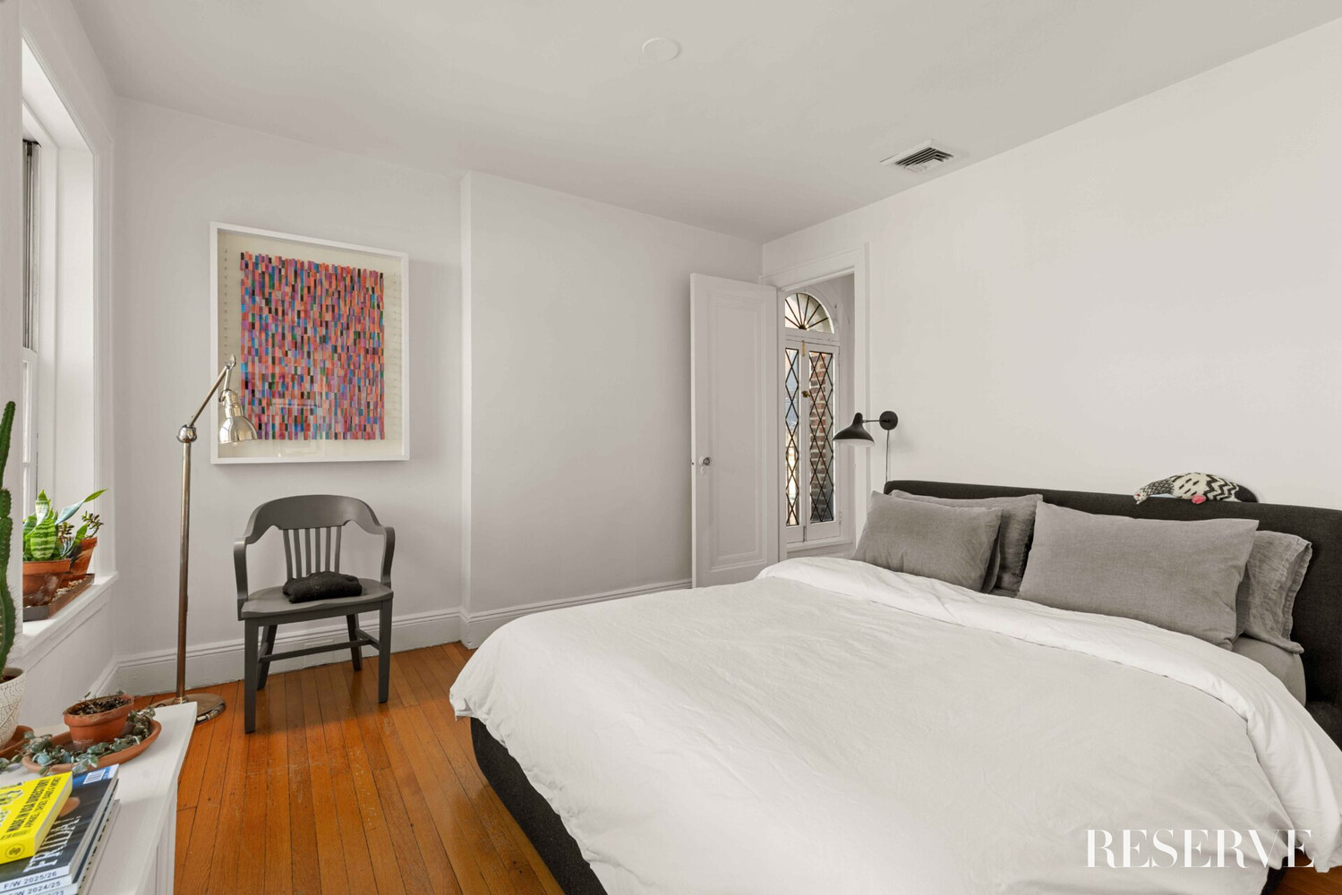 29 Perry Street, Unit 5R Manhattan, NY 10014 - Photo 7 of 14 a bedroom with a bed and a chair