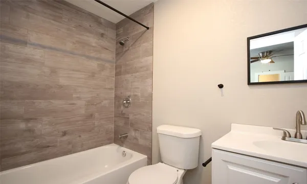 a bathroom with a toilet and a tub