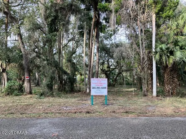 a sign that is sitting in the middle of a forest