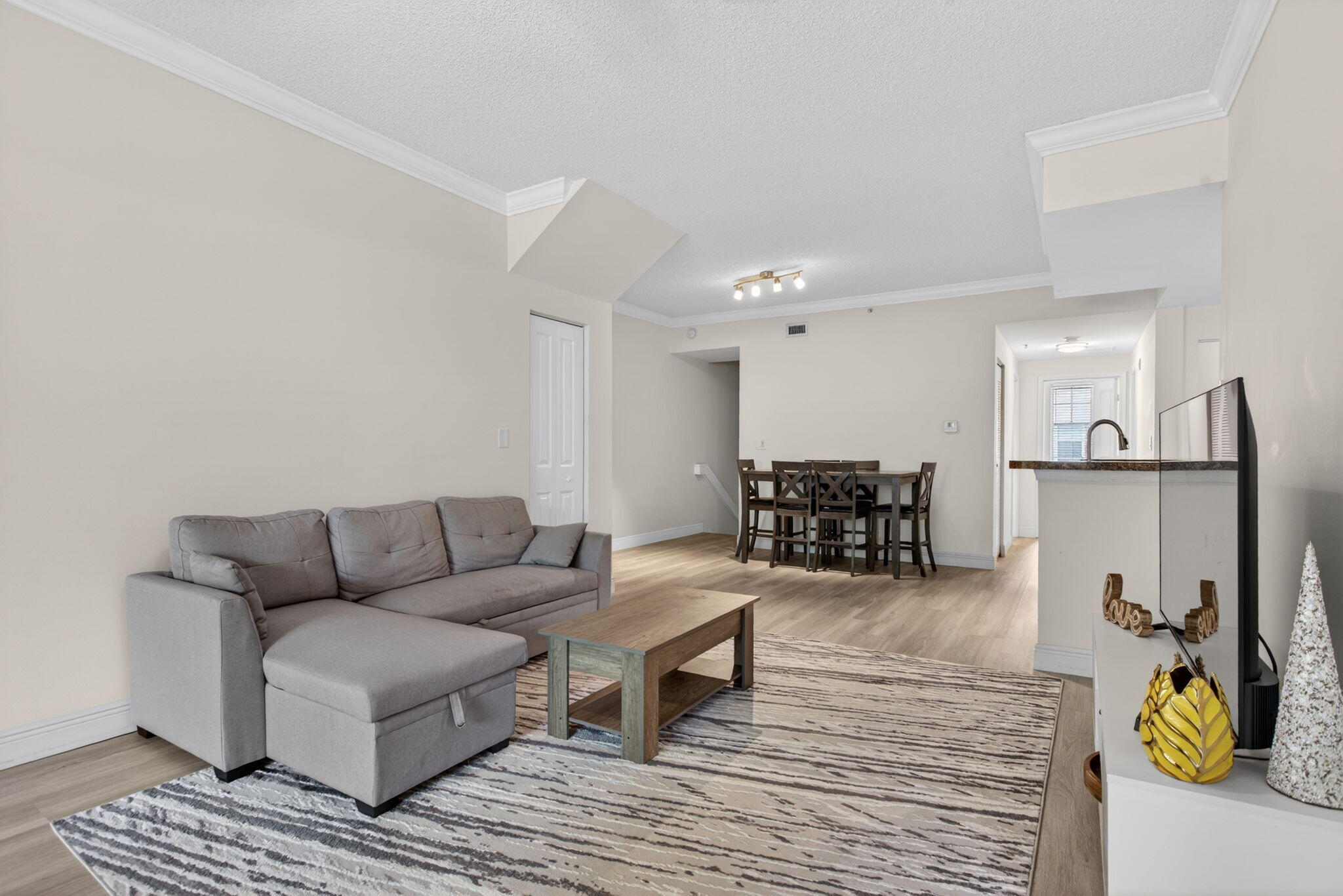 5880 West Sample Road, Unit 206 Coral Springs, FL 33067 - Photo 13 of 37 a living room with furniture and a table