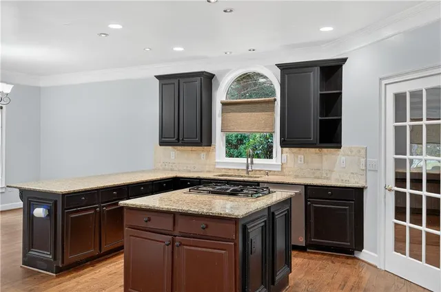 a kitchen with a sink stove and cabinets