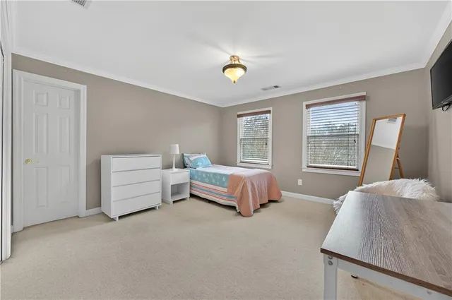 a spacious bedroom with a bed and a couch