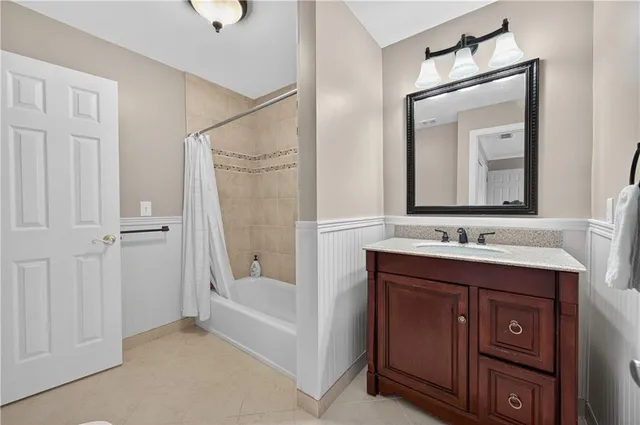 a bathroom with a tub sink and mirror