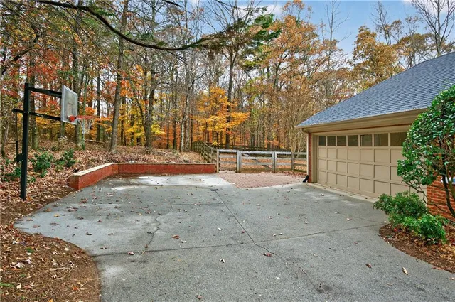 a view of entrance gate of house and car parked