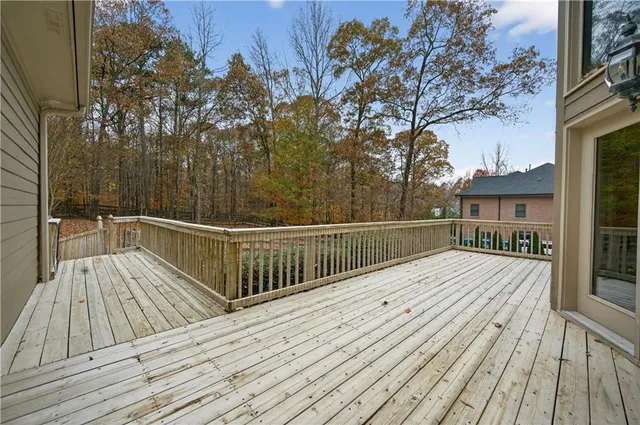 a view of balcony with wooden floor and fence