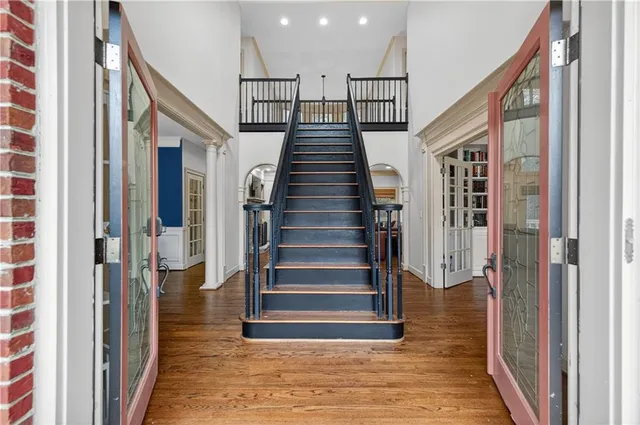 a view of entryway and hall with wooden floor