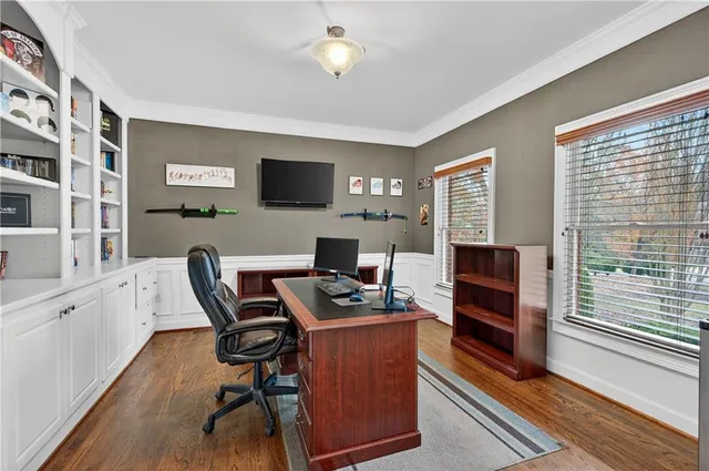 a view of a workspace with furniture and a window