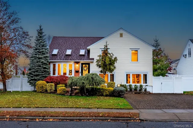 a front view of house with yard and green space