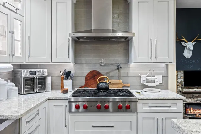 a stove top oven sitting inside of a kitchen