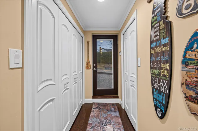 a view of a hallway with wooden floor and closet