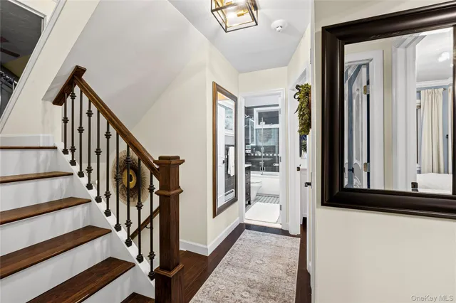 a view of an entryway with wooden floor and door