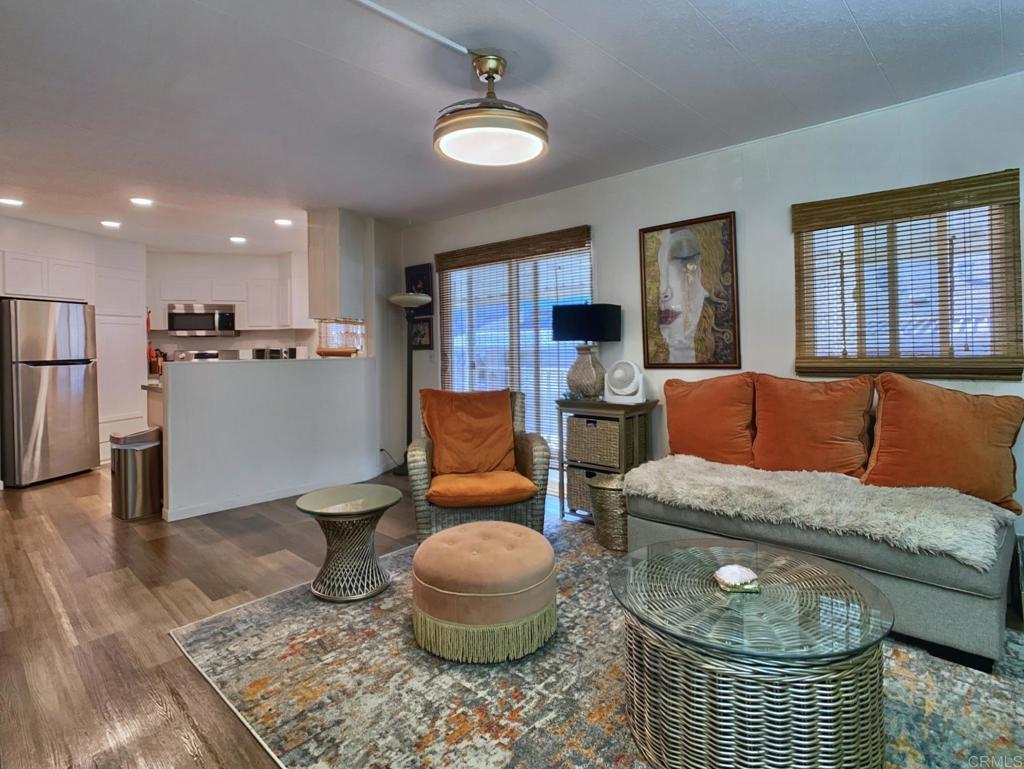 15420 Olde Highway 80, Unit 166 El Cajon, CA 92021 - Photo 11 of 26 a living room with furniture and a chandelier