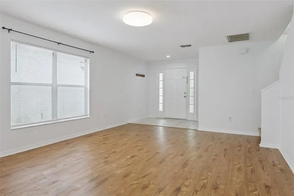 a view of an empty room and wooden floor