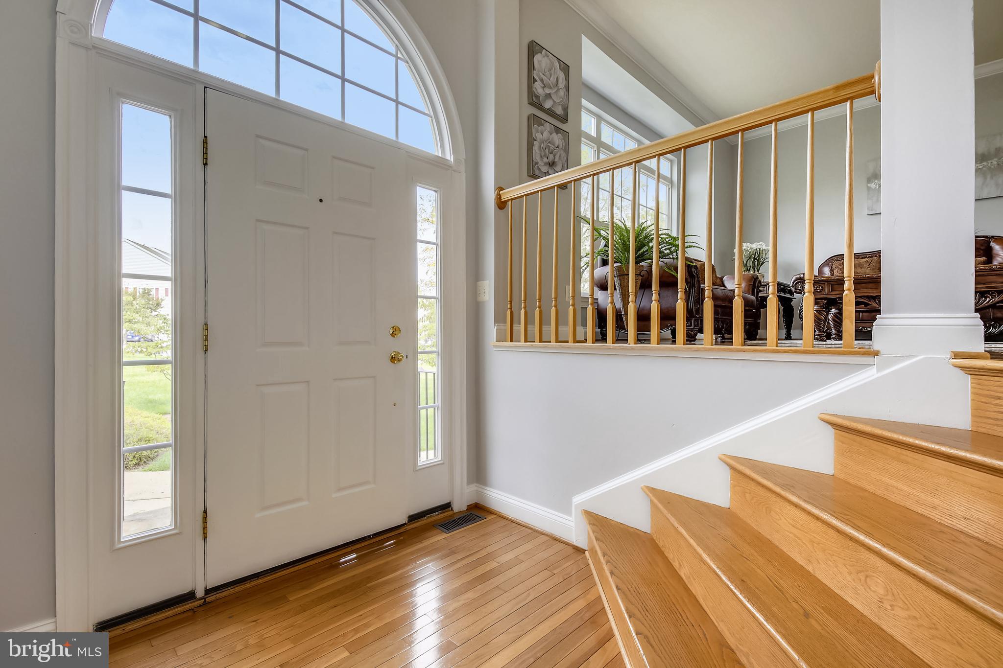 Inviting Entry Foyer with Arched Windows