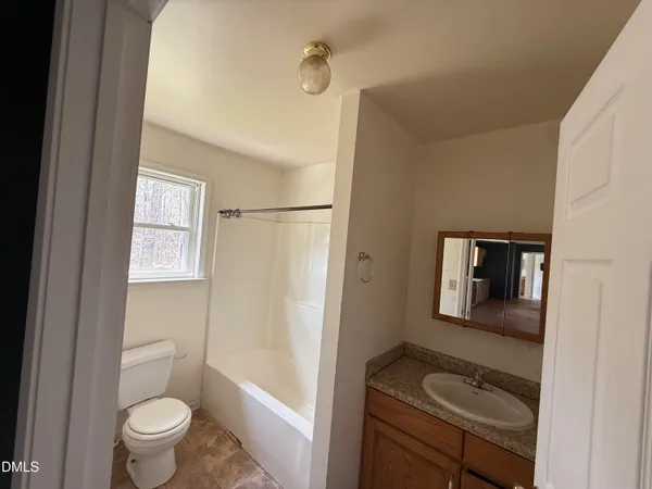 a bathroom with a toilet sink and tub