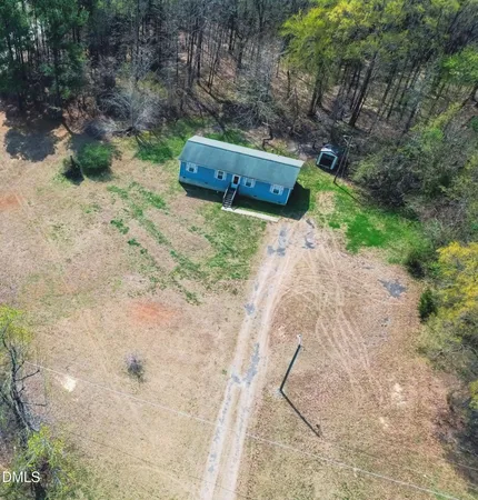 a view of a dry yard with wooden fence