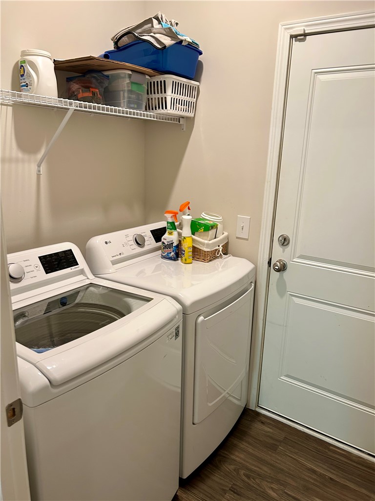 170 Capslock Trail Pendleton, SC 29670 - Photo 17 of 22 Functional utility space includes built-in shelving, durable wood-look flooring, and a dedicated laundry setup.