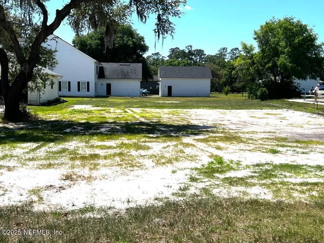 a view of a swimming pool with a lawn chairs under an umbrella