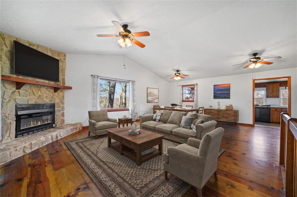 421 Cherokee Court Ellijay, GA 30540 - Photo 2 of 62 a living room with furniture a flat screen tv and a fireplace