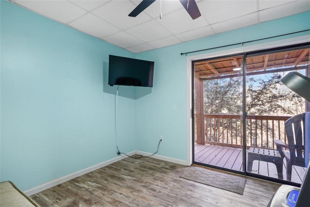 421 Cherokee Court Ellijay, GA 30540 - Photo 24 of 62 a view of an empty room with a window and wooden floor