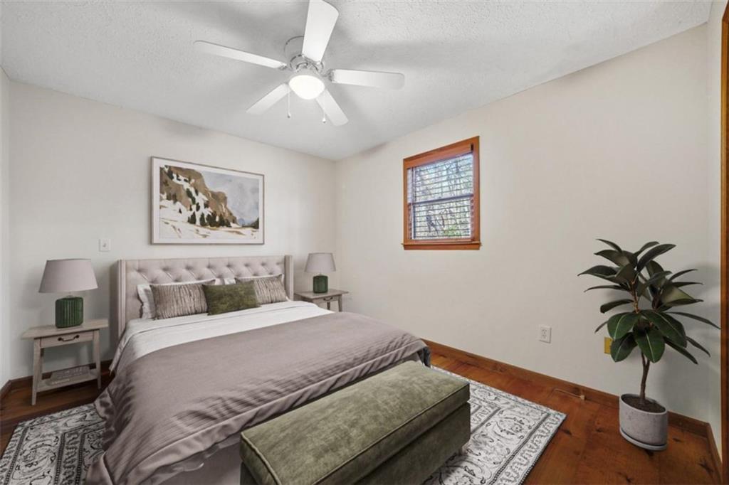 421 Cherokee Court Ellijay, GA 30540 - Photo 3 of 62 a bedroom with a large bed and a potted plant