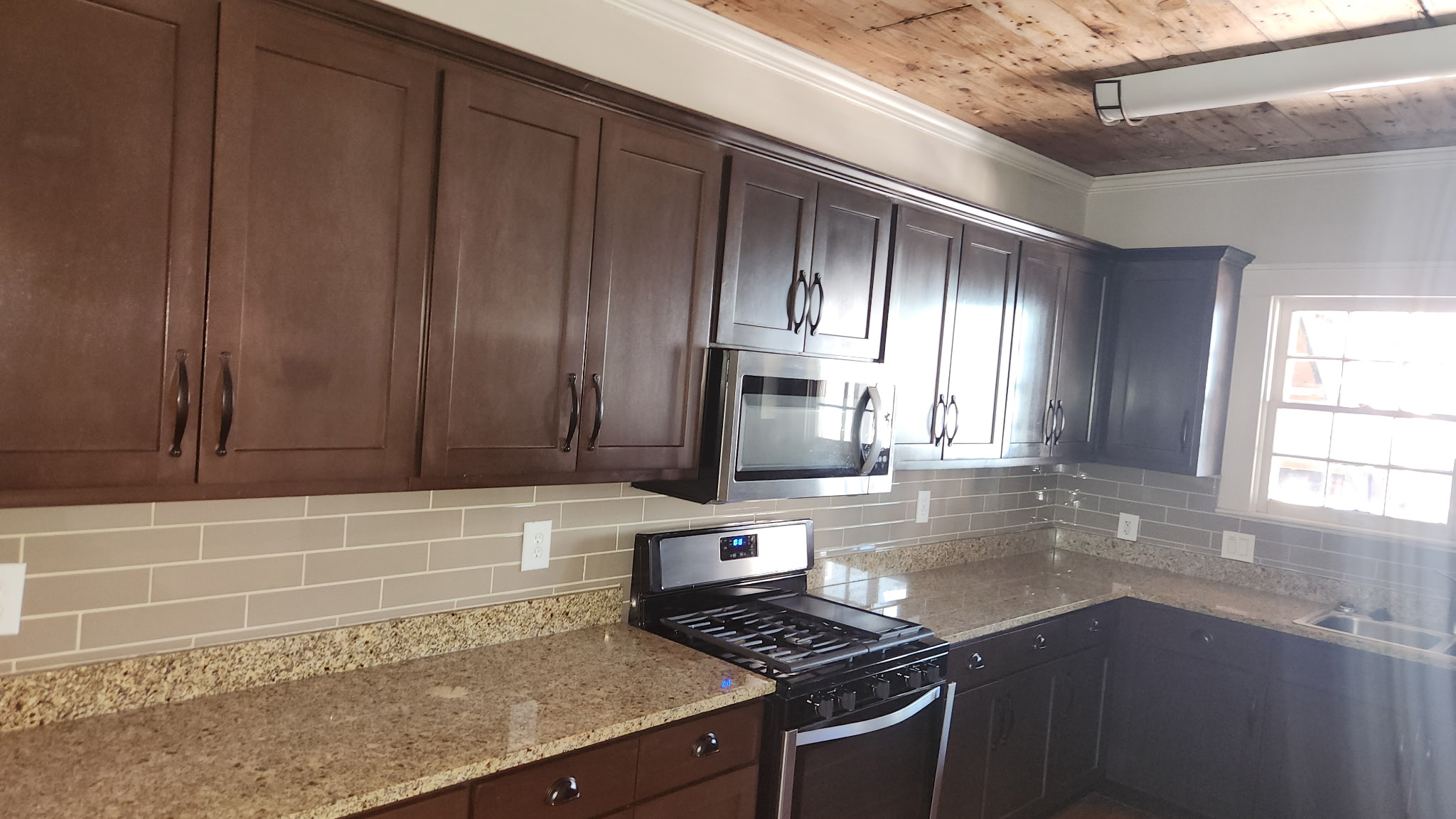 1709 Enfield Road, Unit A Austin, TX 78703 - Photo 4 of 8 Rich cabinetry and granite counters define this thoughtfully designed kitchen, complete with modern appliances.