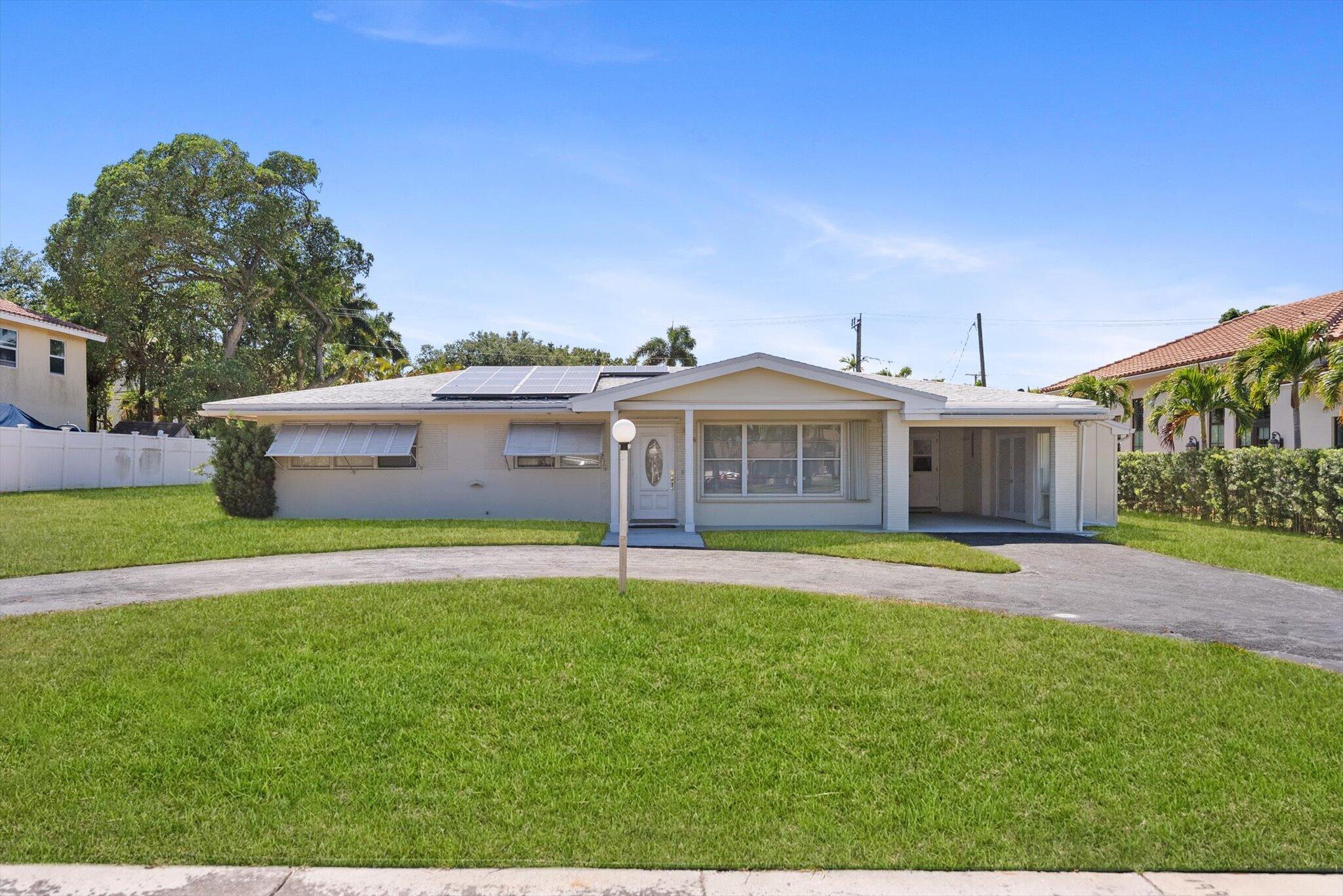 1035 Northwest 4th Avenue Boca Raton, FL 33432 - Photo 16 of 16 a front view of house with yard and outdoor seating