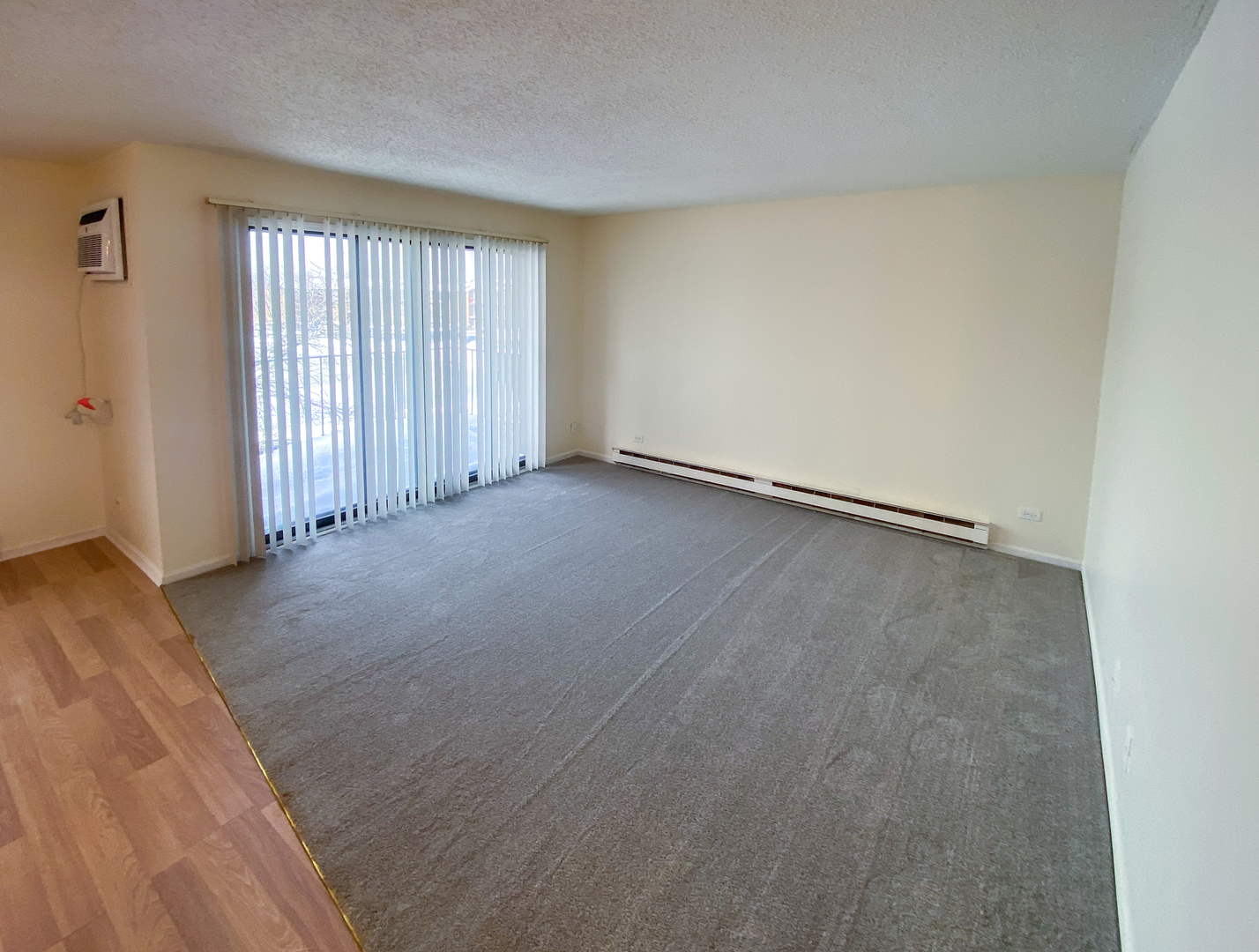661 Briar Hill Lane, Unit 5 Addison, IL 60101 - Photo 4 of 15 an empty room with wooden floor and windows