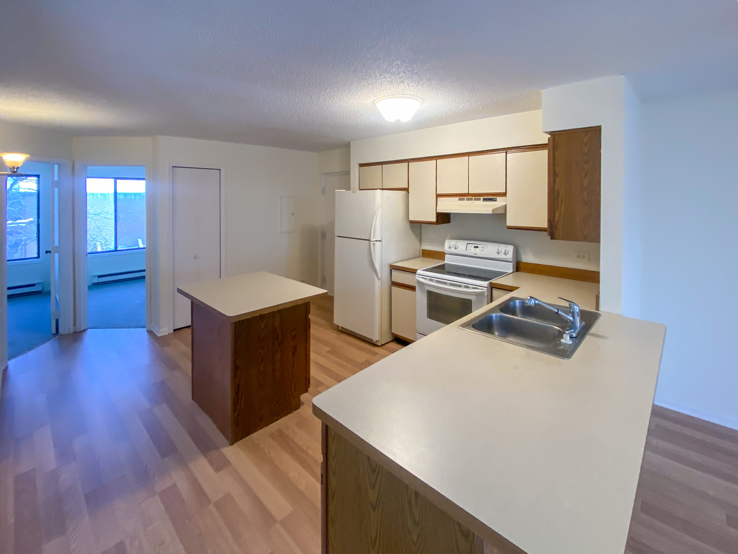 661 Briar Hill Lane, Unit 5 Addison, IL 60101 - Photo 6 of 15 a kitchen with sink a refrigerator and wooden floor
