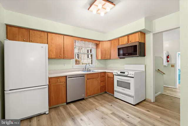 a kitchen with a sink cabinets and stainless steel appliances