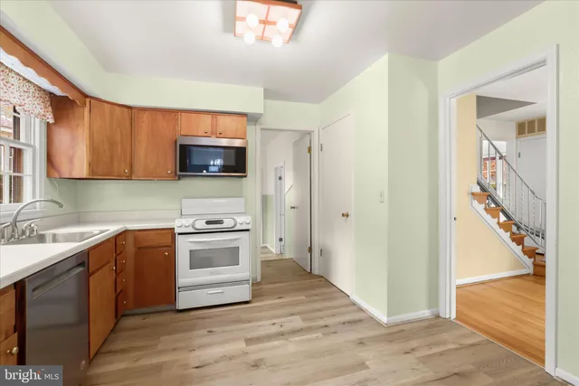 a view of empty room with wooden floor and fireplace