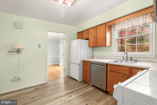 a view of empty room with wooden floor and fireplace