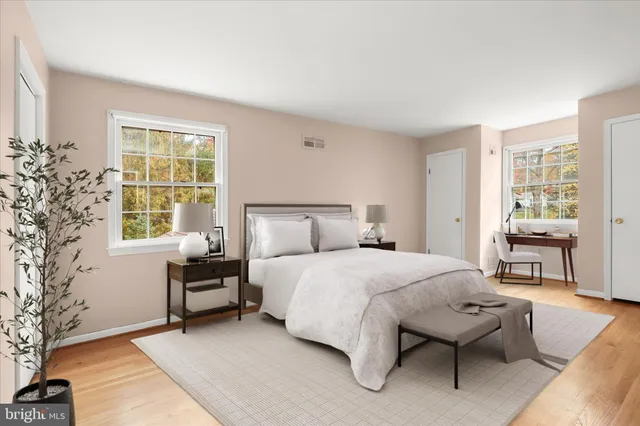 a bedroom with a bed and a large window