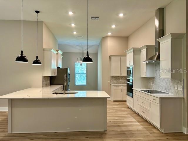 13530 Oldenburg Drive Hudson, FL 34667 - Photo 4 of 13 a large kitchen with stainless steel appliances kitchen island a large counter top a stove a sink and a refrigerator