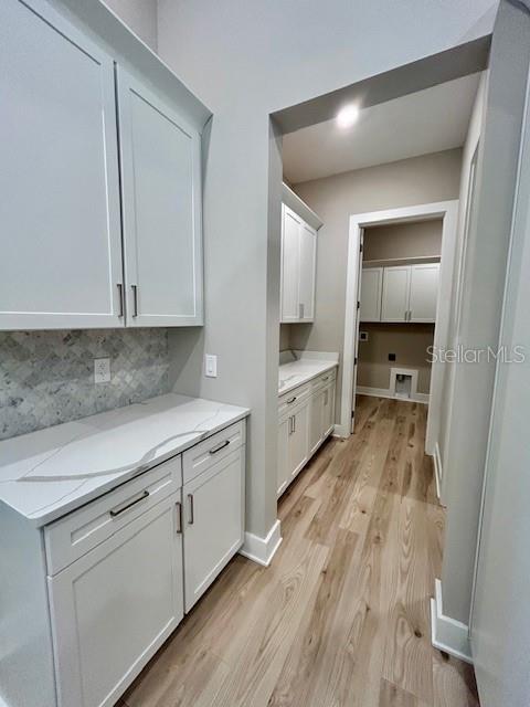 13530 Oldenburg Drive Hudson, FL 34667 - Photo 7 of 13 a kitchen with white cabinets and sink