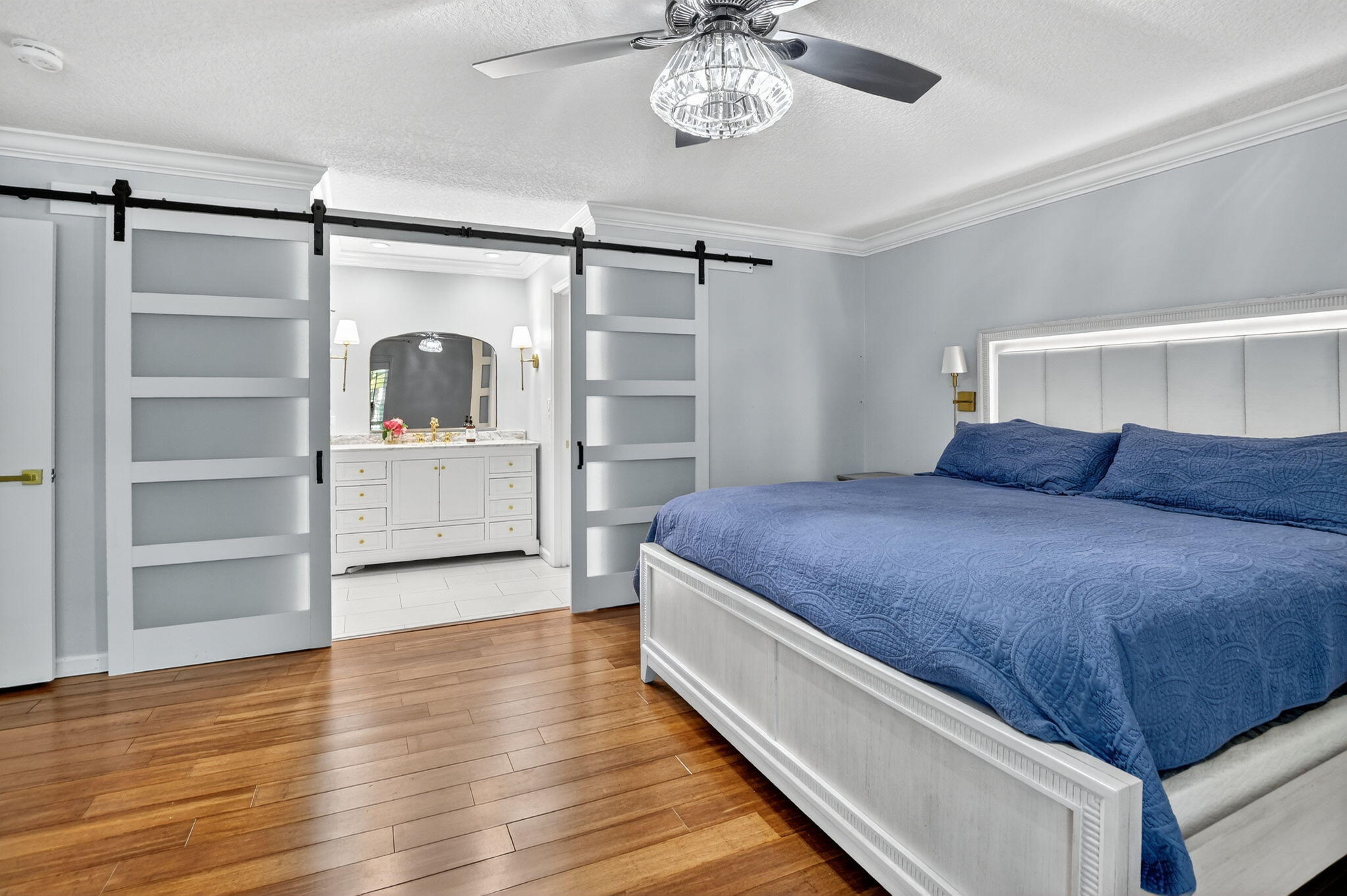 501 Southwest 1st Street Boca Raton, FL 33432 - Photo 17 of 69 a bedroom with a bed and a chandelier