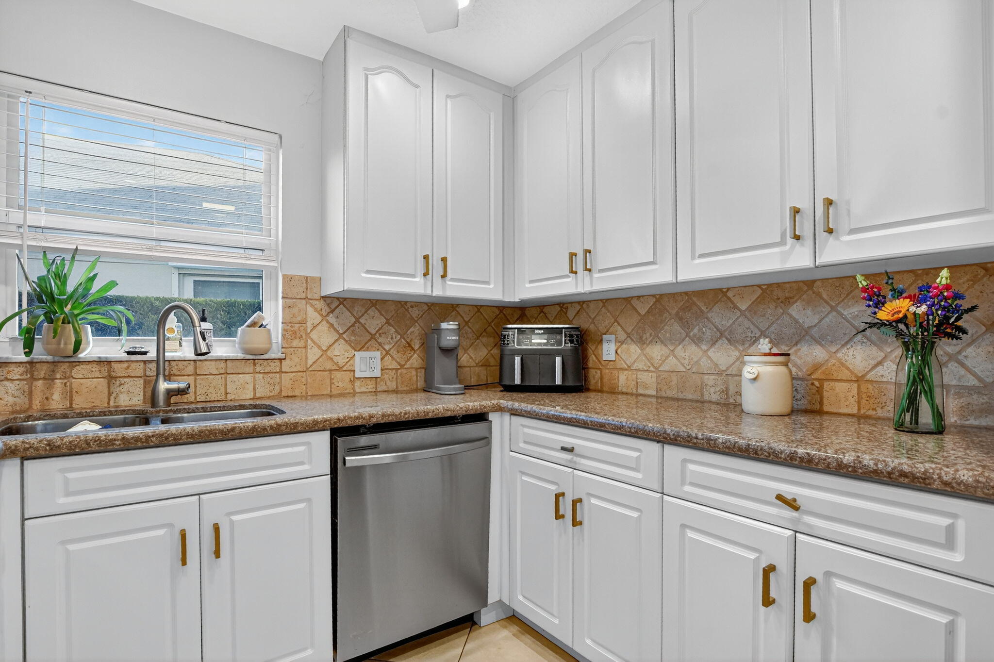 501 Southwest 1st Street Boca Raton, FL 33432 - Photo 6 of 69 a kitchen with granite countertop white cabinets and white stainless steel appliances with a window