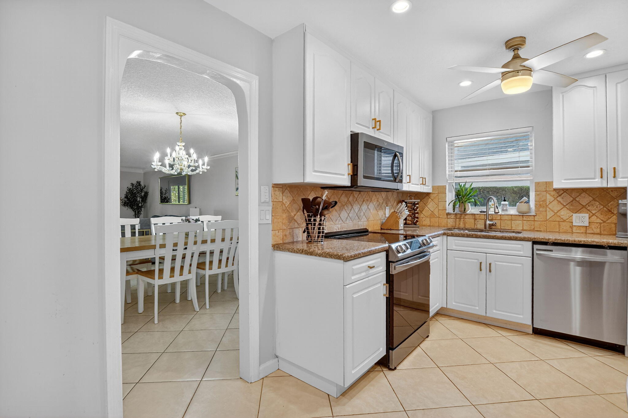 501 Southwest 1st Street Boca Raton, FL 33432 - Photo 7 of 69 a kitchen with granite countertop cabinets a sink and appliances