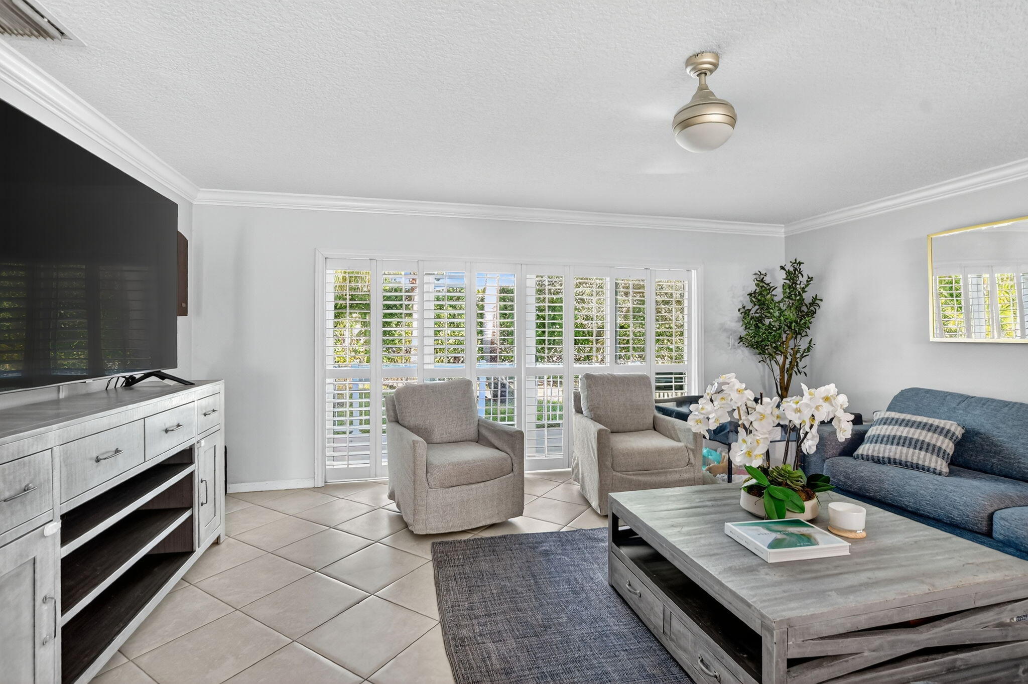 501 Southwest 1st Street Boca Raton, FL 33432 - Photo 8 of 69 a living room with furniture a flat screen tv and a fireplace