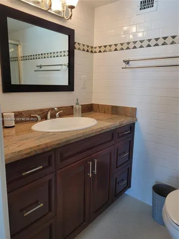 a bedroom with a bed and a large mirror