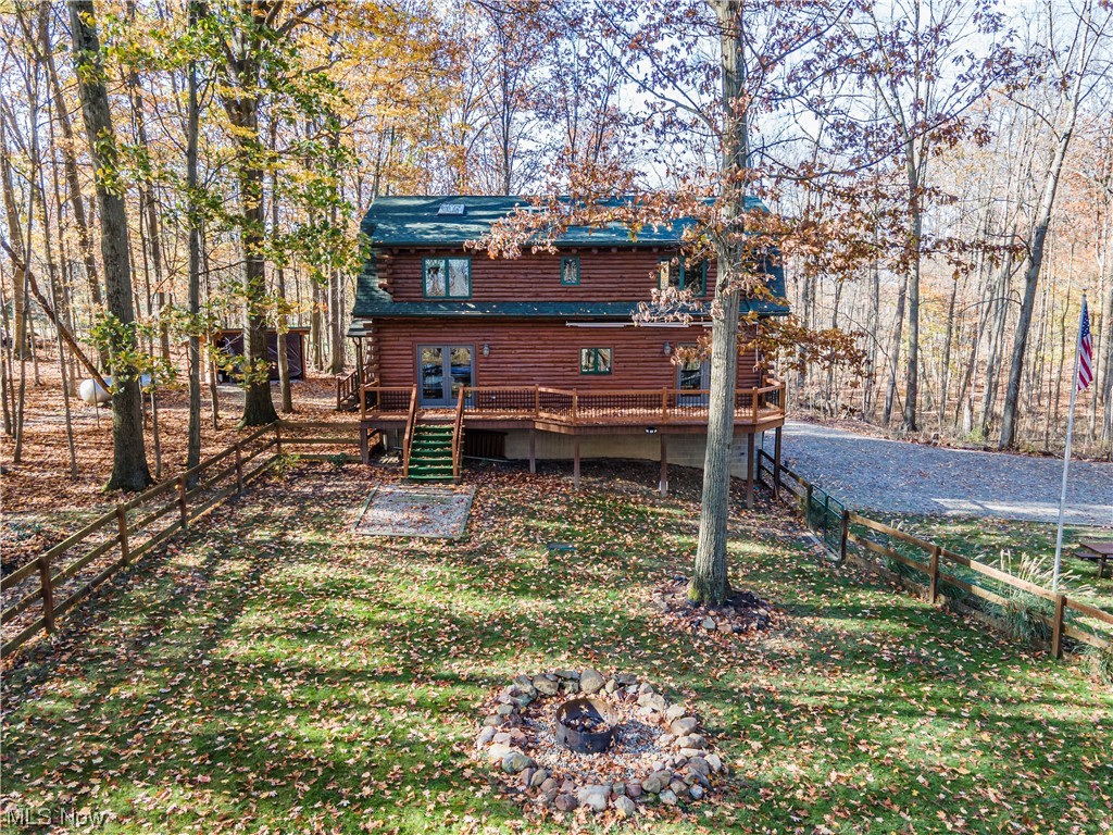 4069 Erhart Road Medina, OH 44256 - Photo 27 of 30 Back of property featuring a wooden deck and an outdoor fire pit