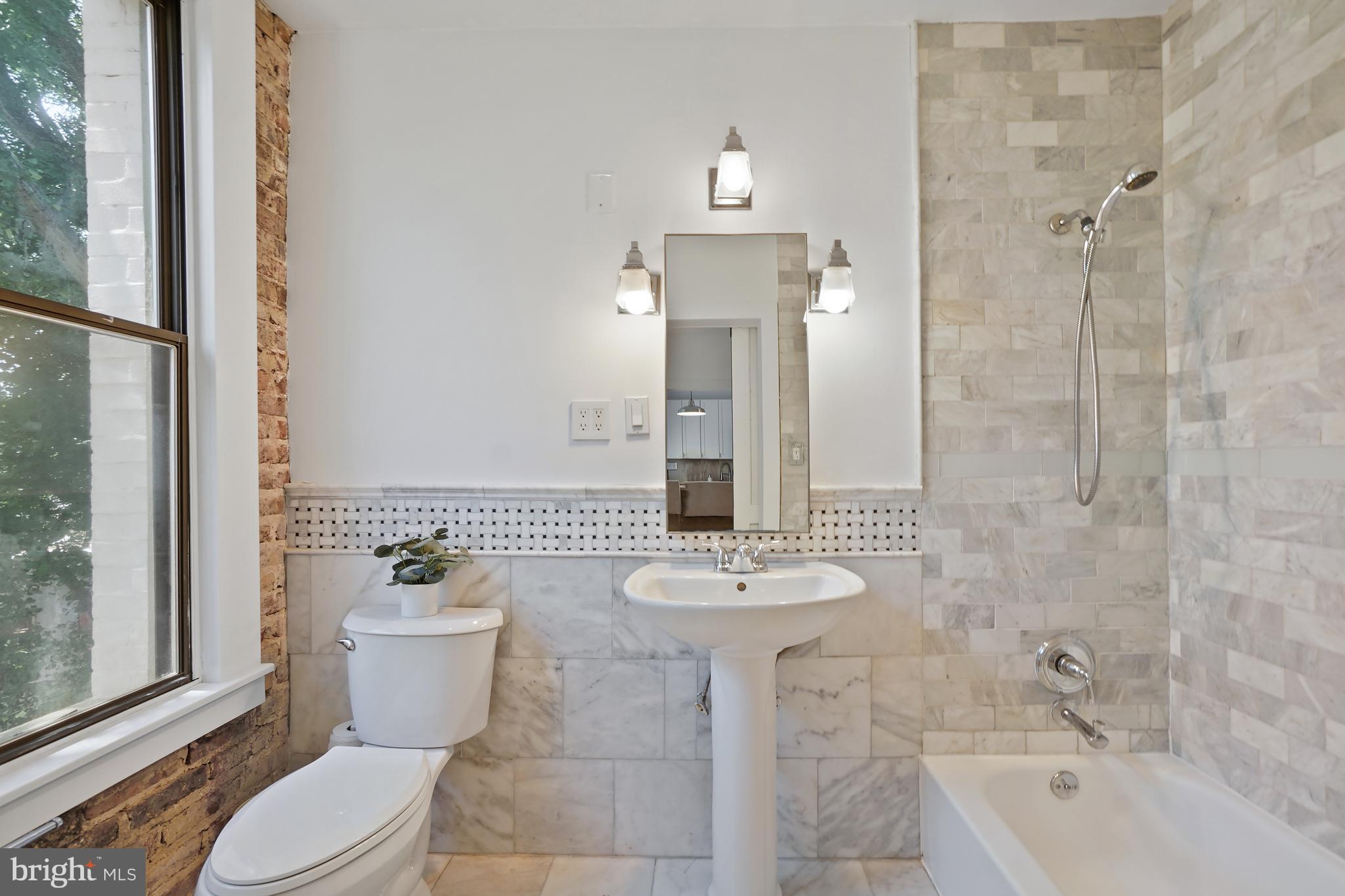 1822 15th Street Northwest, Unit 303 Washington, DC 20009 - Photo 14 of 22 a bathroom with a sink toilet and shower