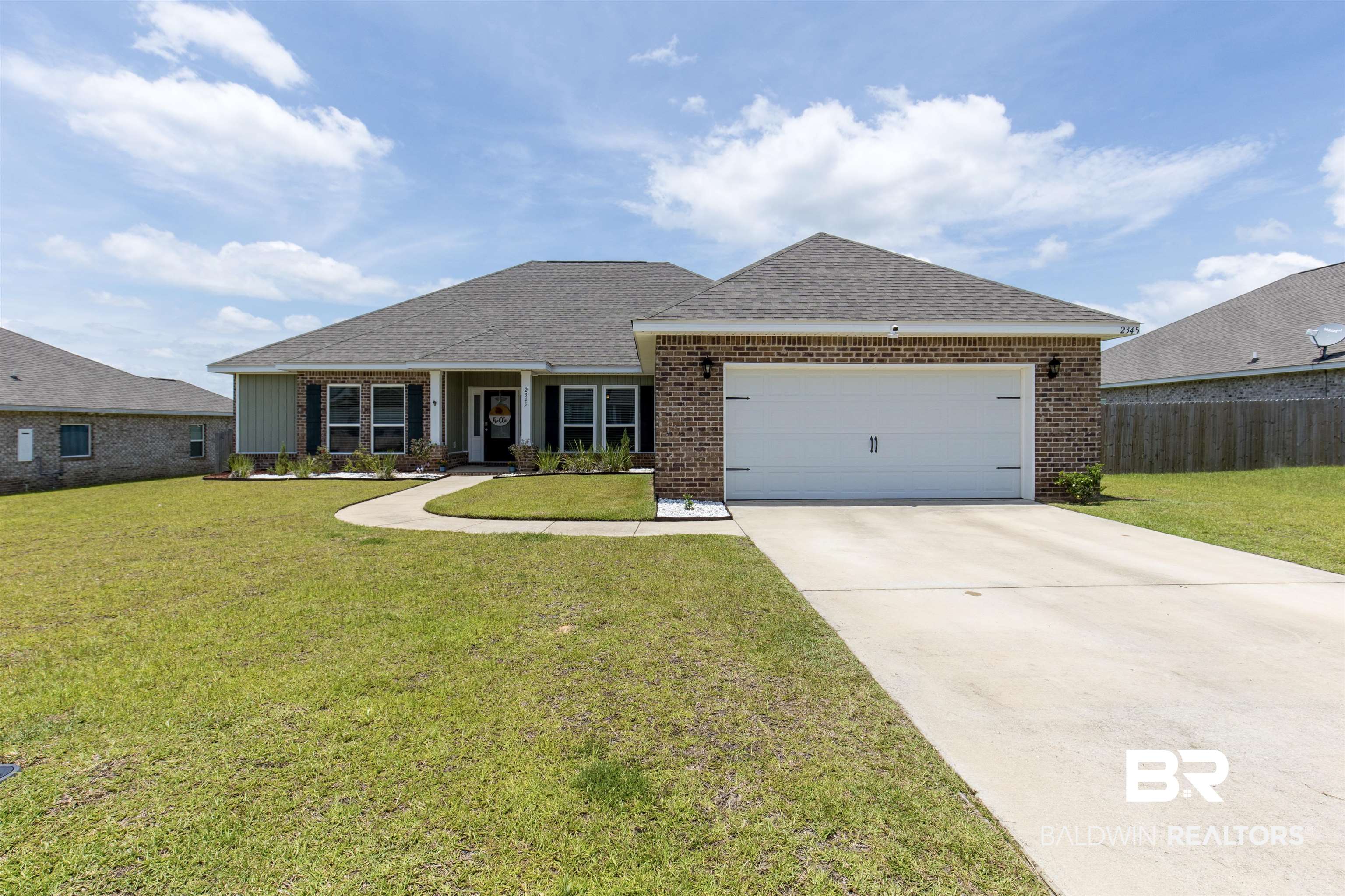 2345 Laurel Street Semmes, AL 36575 - Photo 1 of 31 Ranch-style house featuring brick siding, a garage, driveway, and a shingled roof