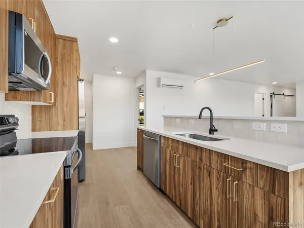 a kitchen with counter top space cabinets and stainless steel appliances