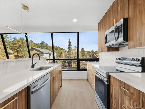 a kitchen with a sink a stove and cabinets